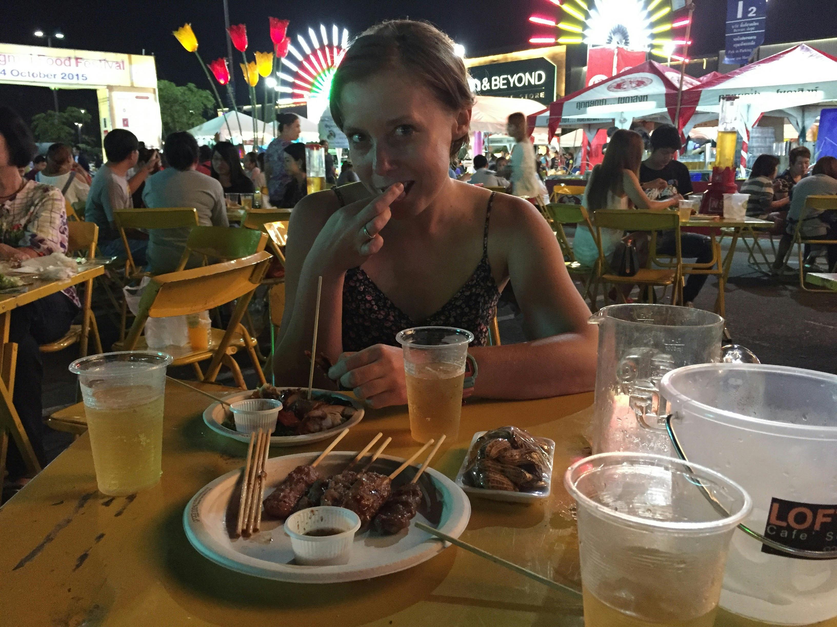 Travel healthy - a girl eating at a local restaurant in Thailand. 