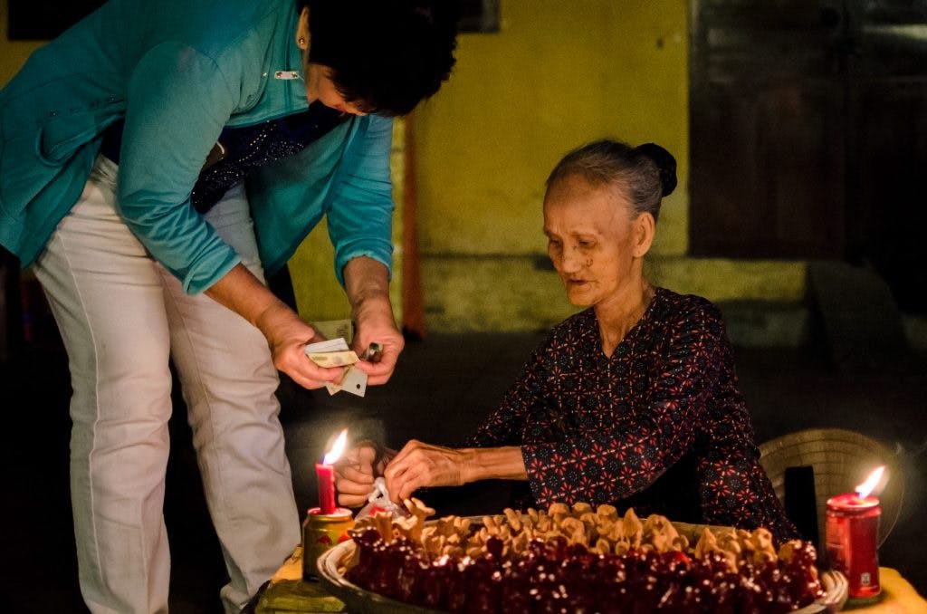Old lady selling figurines in the streets of Hoi An