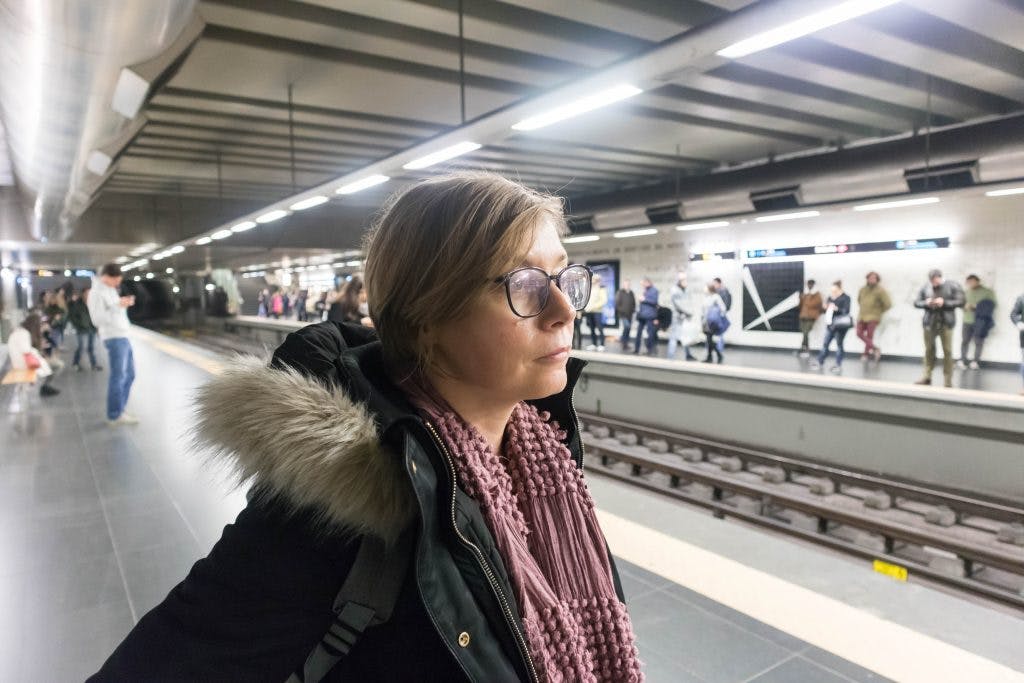 a girl on a platform in lisbon metro