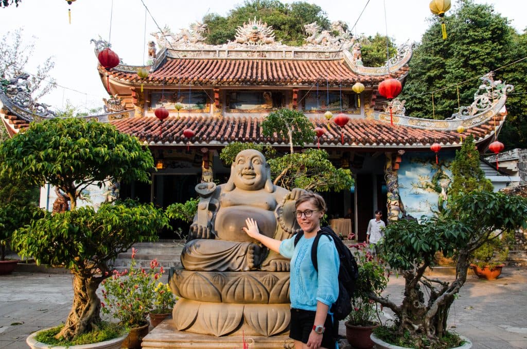 Rubbing Buddha's belly for good luck.