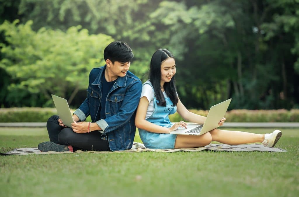 relationships in thailand. a couple sitting on grass