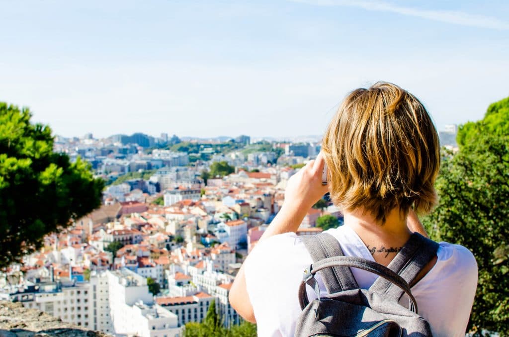 a girl taking picture at st georges castle in lisbon 