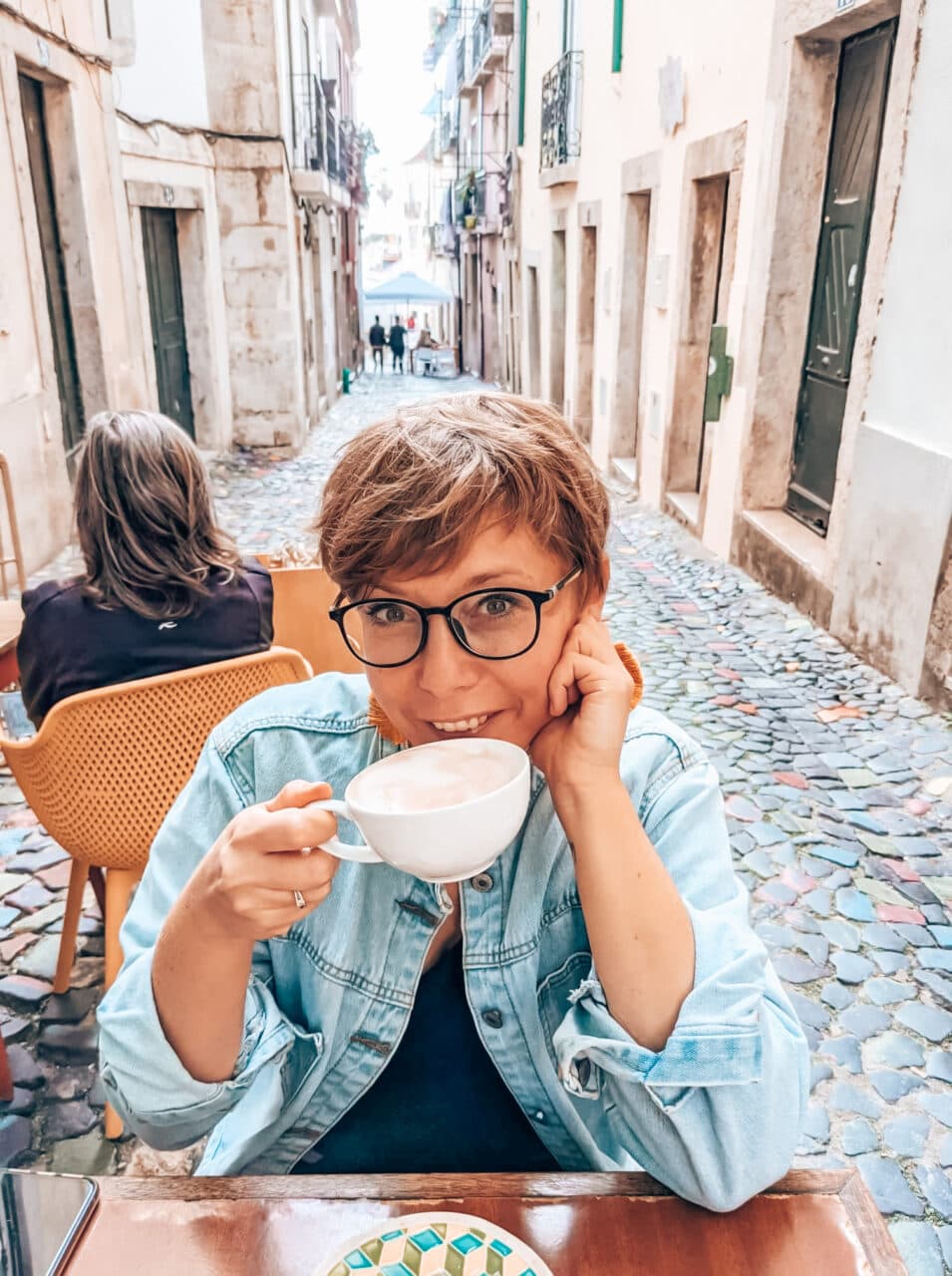 Joanna in Alfama, Lisbon, drinking coffee
