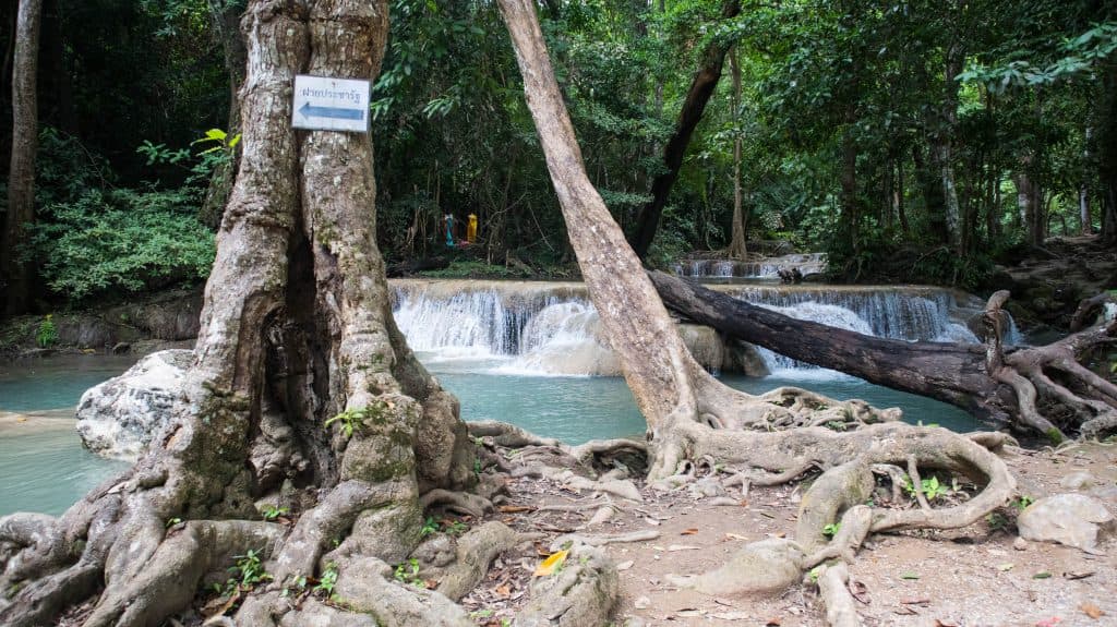 the first tier of the erawan waterfall blue water cascading down 