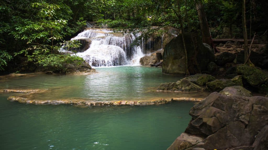 erawan waterfall water cascading into a pool
