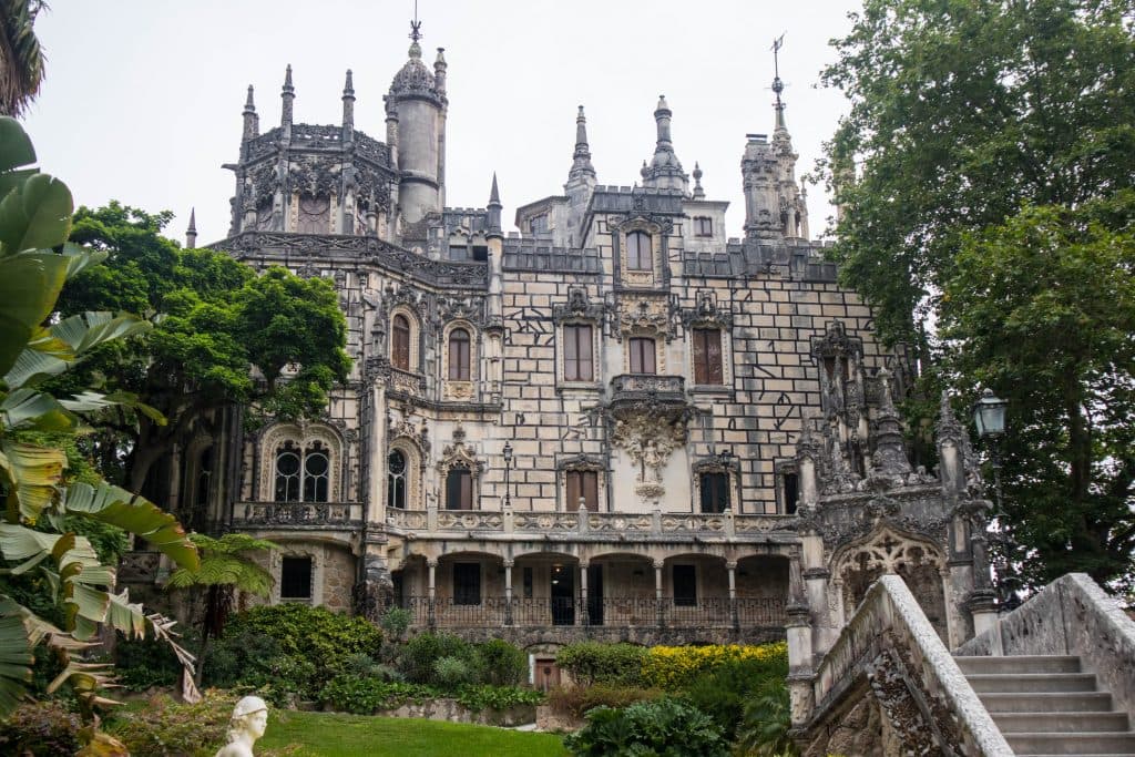 the palace of quinta de regailera in sintra seen from the outside surrounded by garden 
