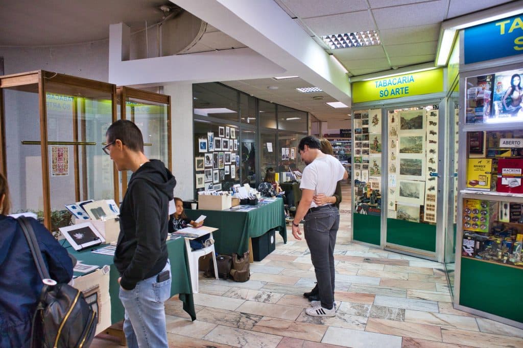 the interior of a shopping centre with an art exhibition in porto, portugal