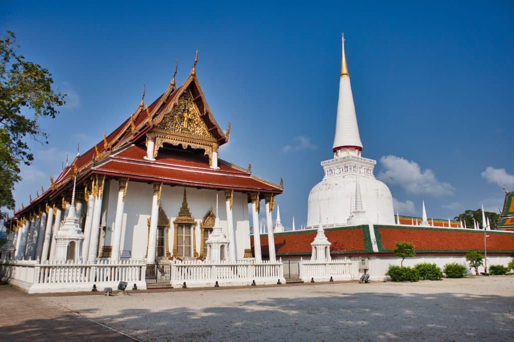 a thai temple in nakhon si thammarat with a white chedi
