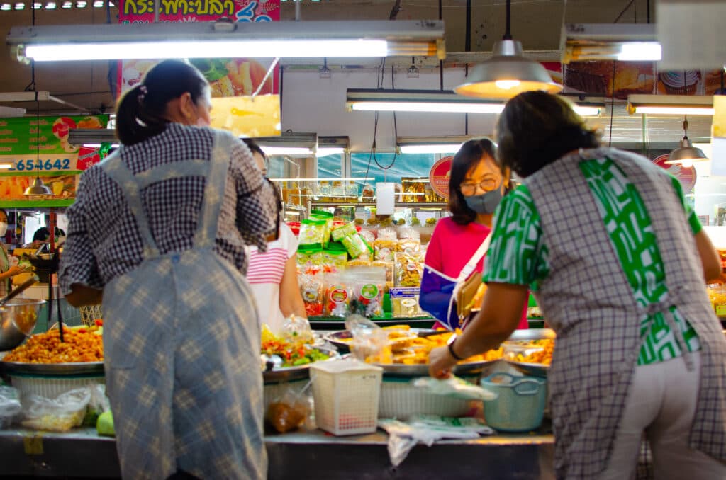 Three woman shopping at a local market in Chiang Mai. 