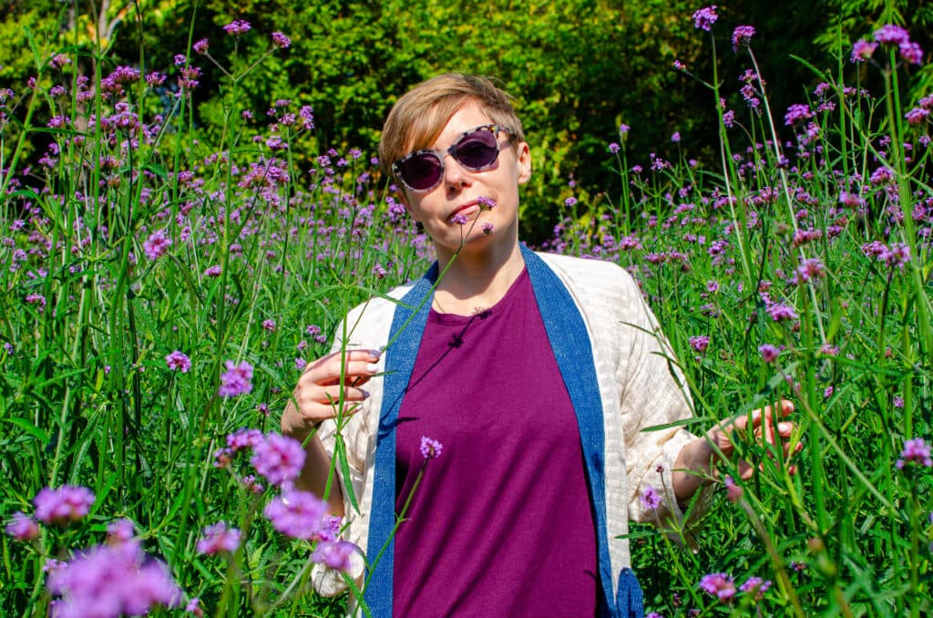 Joanna stands in the field of flowers in a waterfall park, near Chiang Mai. 