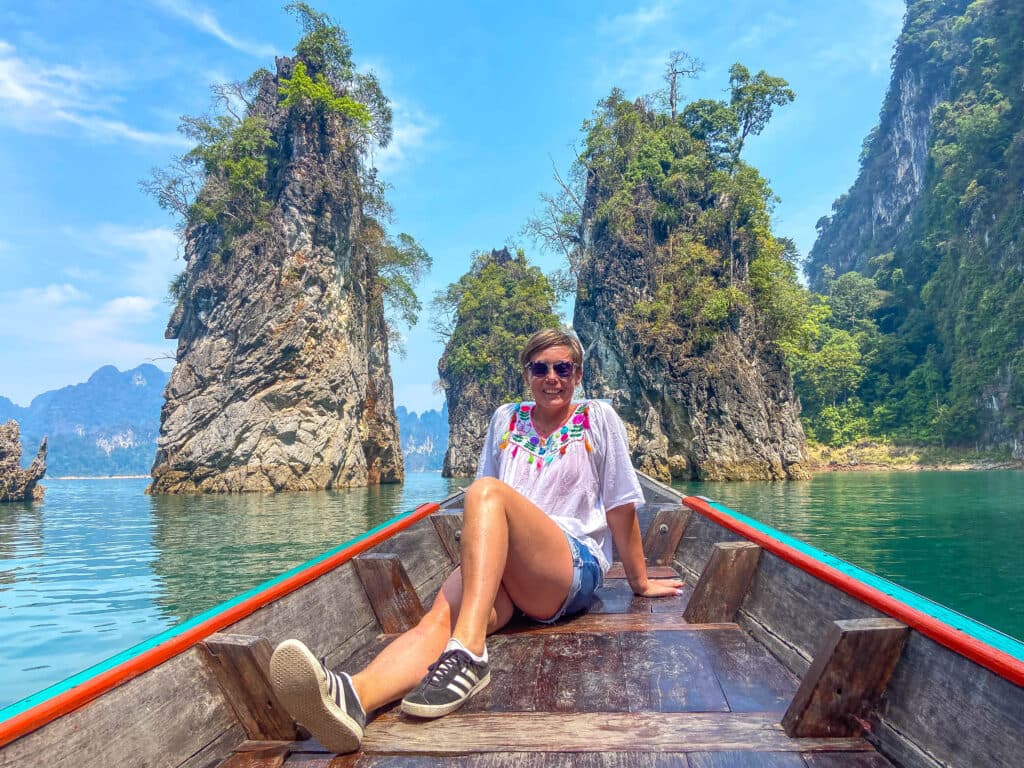 Joanna sits on a boat on cheow lan lake.