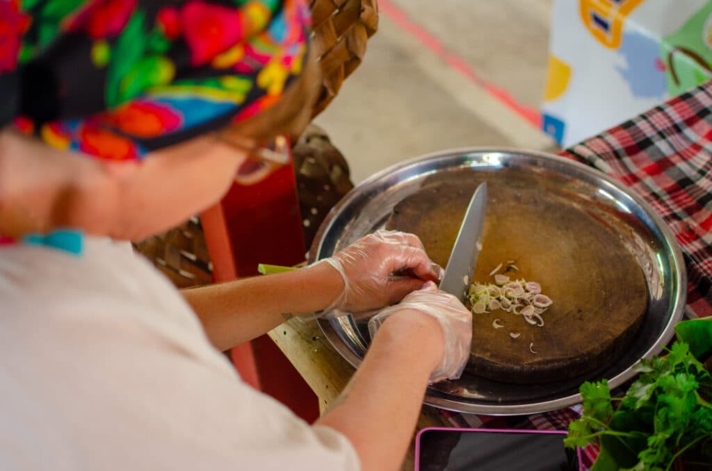 Woman chopping lemon grass. 