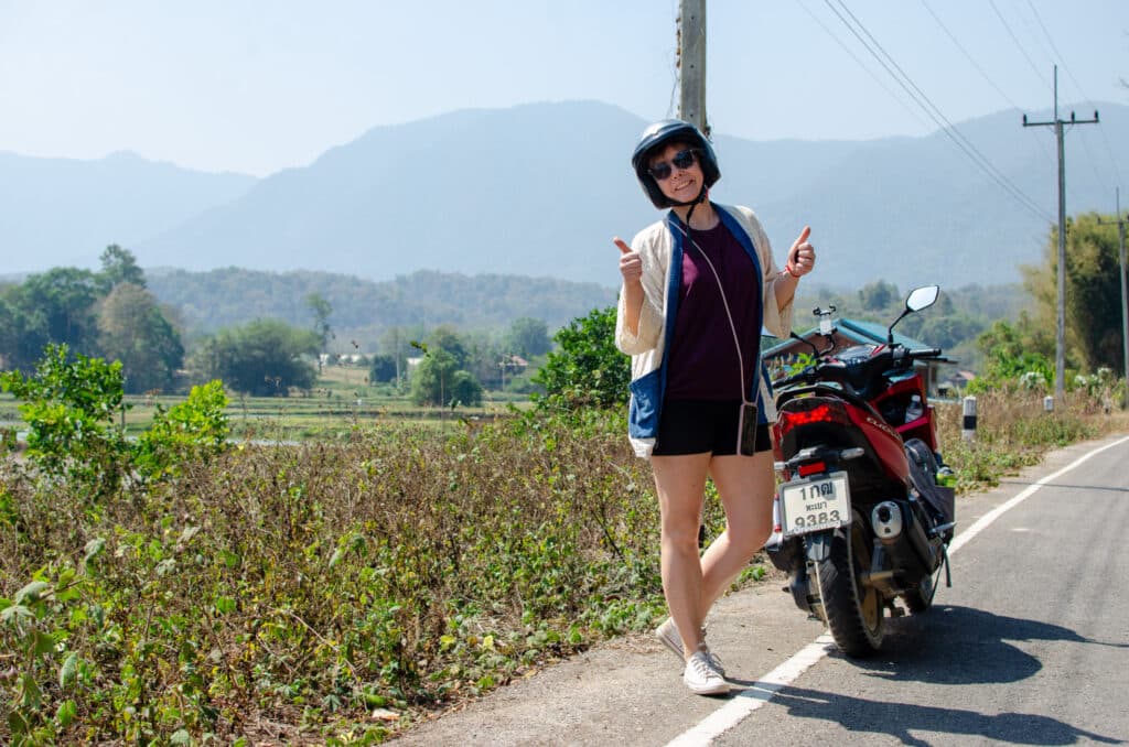 Joanna at a scooter on a road. 