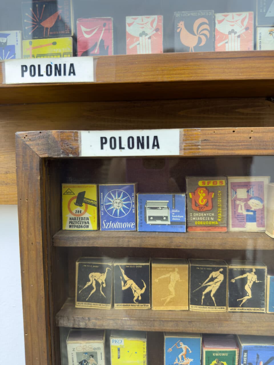 A glass cabinet with match boxes