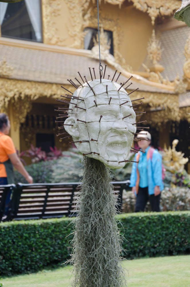 a head with nails at the white temple in chiang rai 