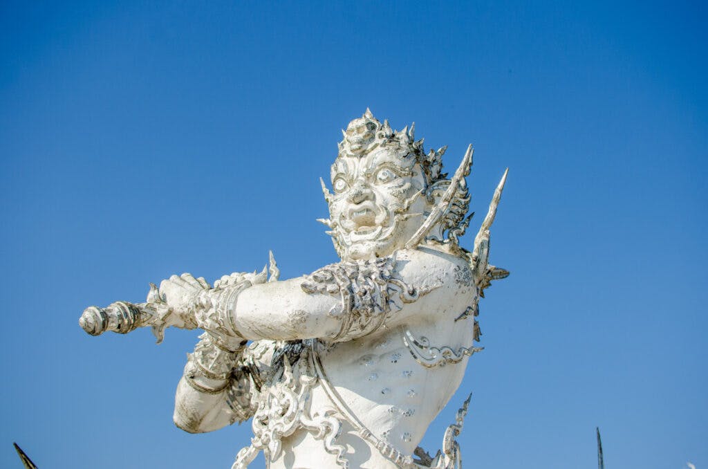 A sculpture of a white Buddhist demon. 