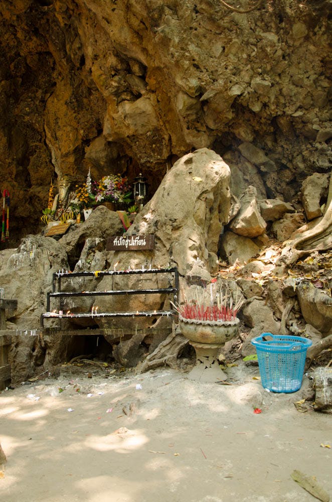 the entrance to the cave with candles and incense in mean hong song, thailand
