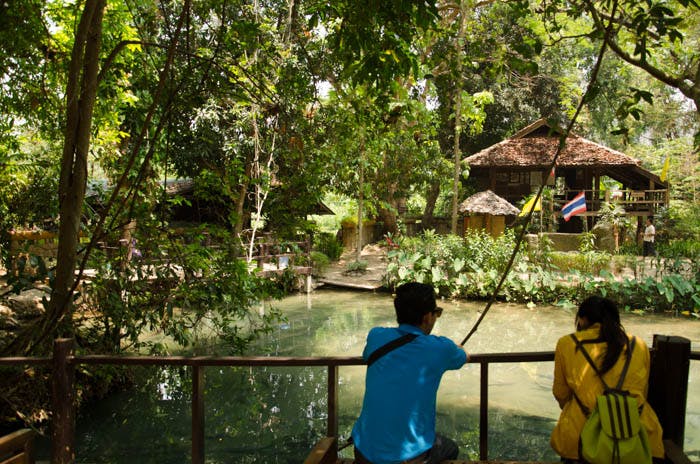 a pond near a cave in mea hong song, thailand