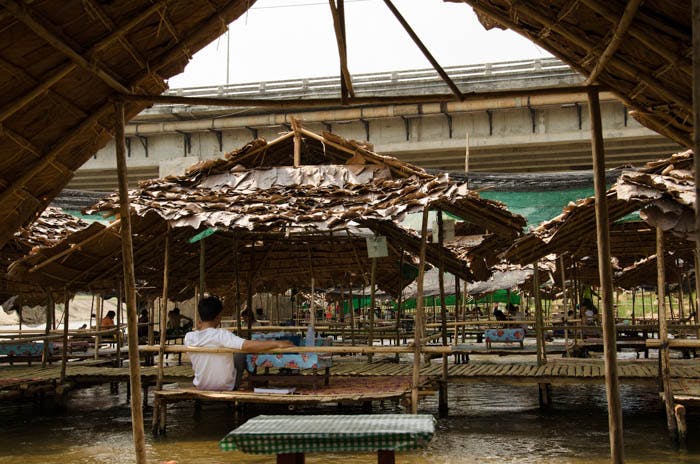 bamboo huts on a river in mea hong song, thailand 