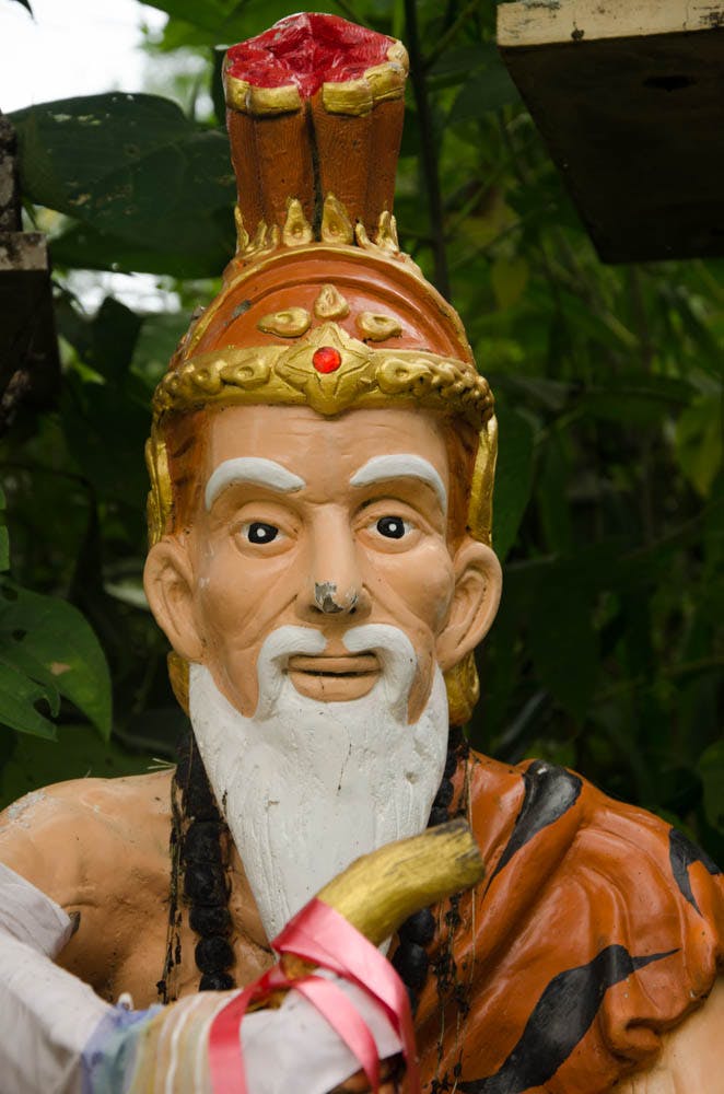 A close up of an old statue of an old man. 