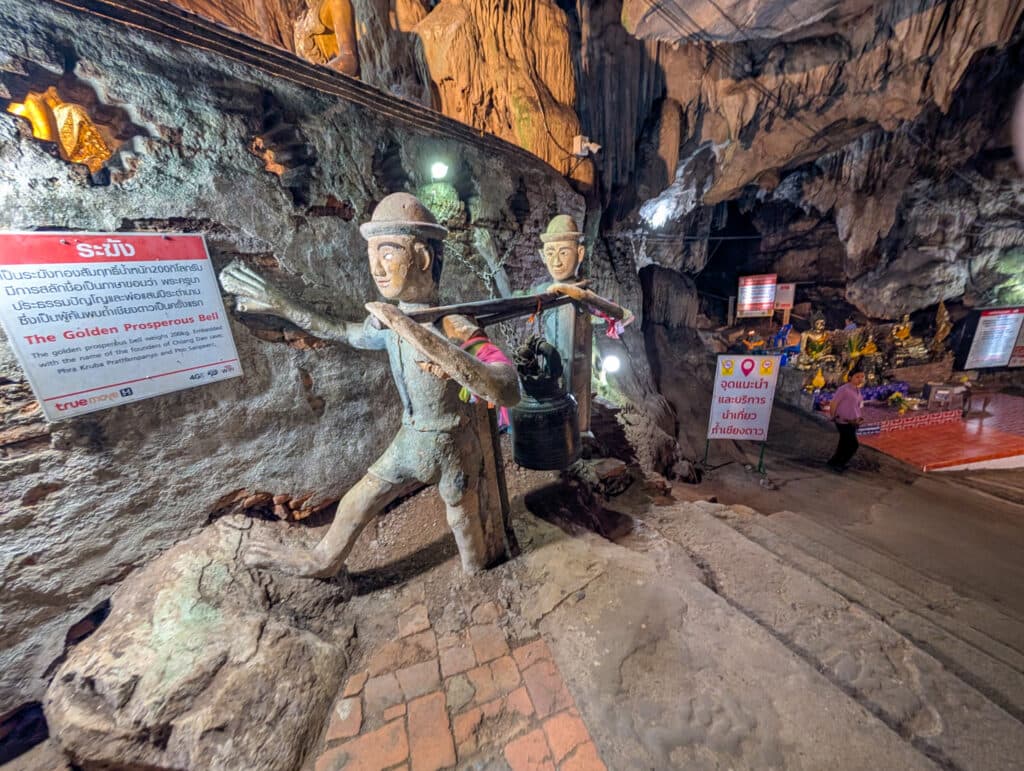 Statues of two workers inside the chiang dao cave.