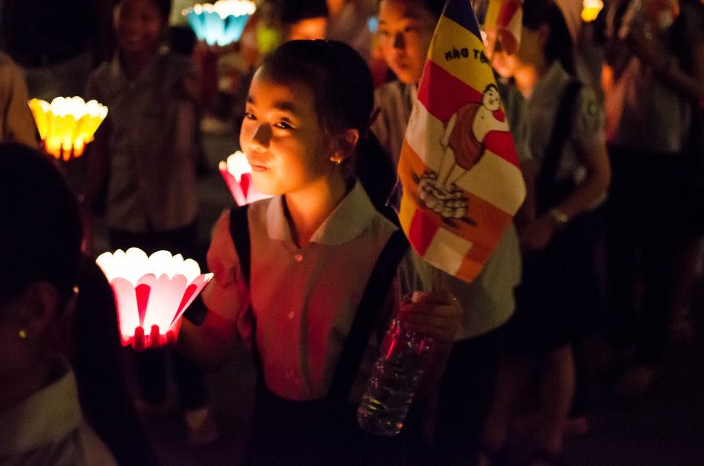 Girl with lantern at a procession during the Lantern Festival in Hoi An