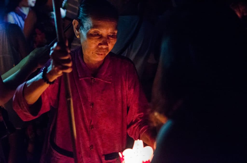 Old lady prepares a lantern