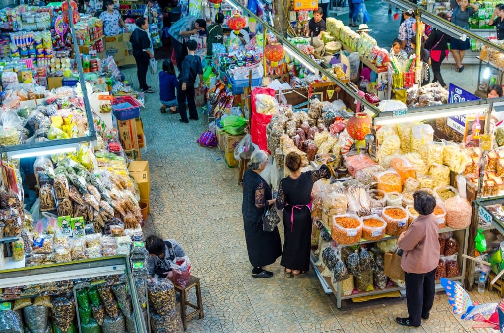 Vendors selling dried fruit and spices at Warorot Market in Chiang Mai