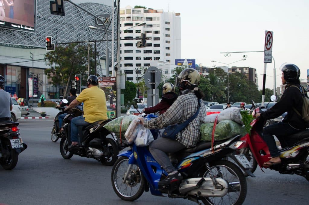 Scooters on a street in Thailand .