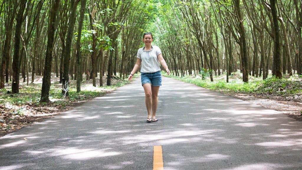 Joanna walking in rubber trees orchard khanom thailand 