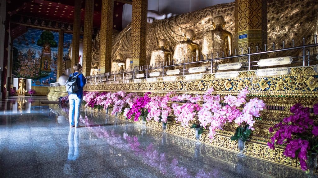 joanna at the reclining buddha statue in blue temple mae taeng