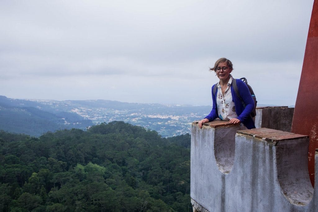 joanna stands on a viewing terrace in sintra on a windy day 