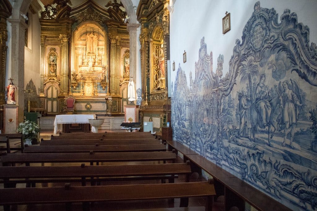 azulejos and an altar in a small church in cacilhas