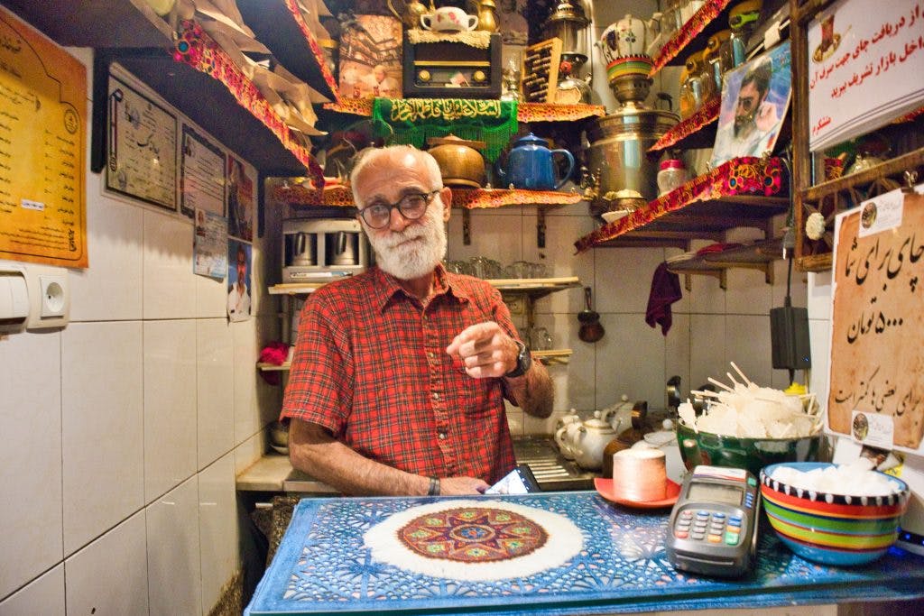 an old man selling tea at gran bazaar teheran