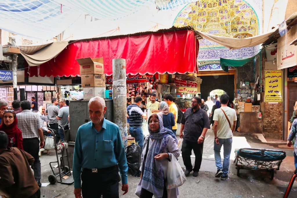 iranian couple walks through the grand bazaar in iran