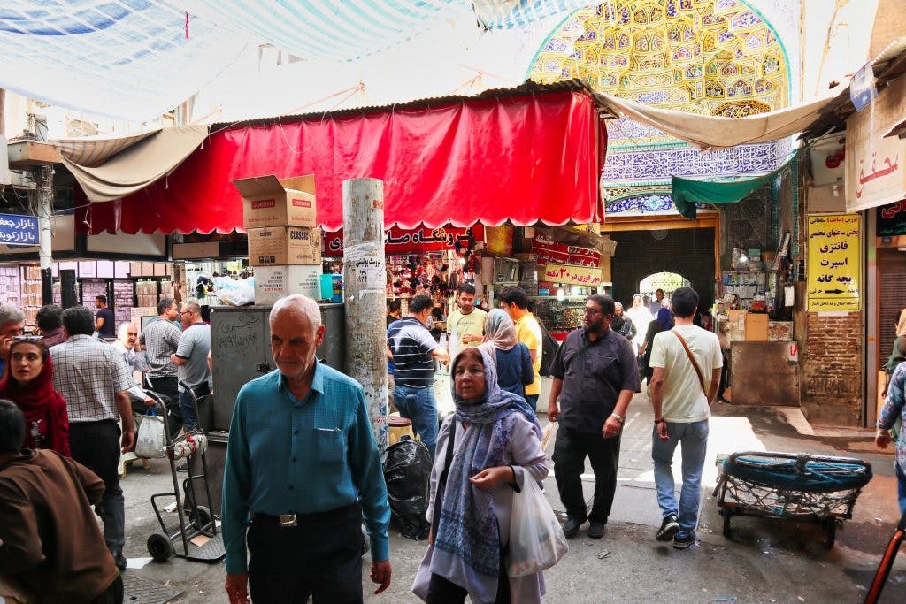 iranian couple walks through the grand bazaar in iran