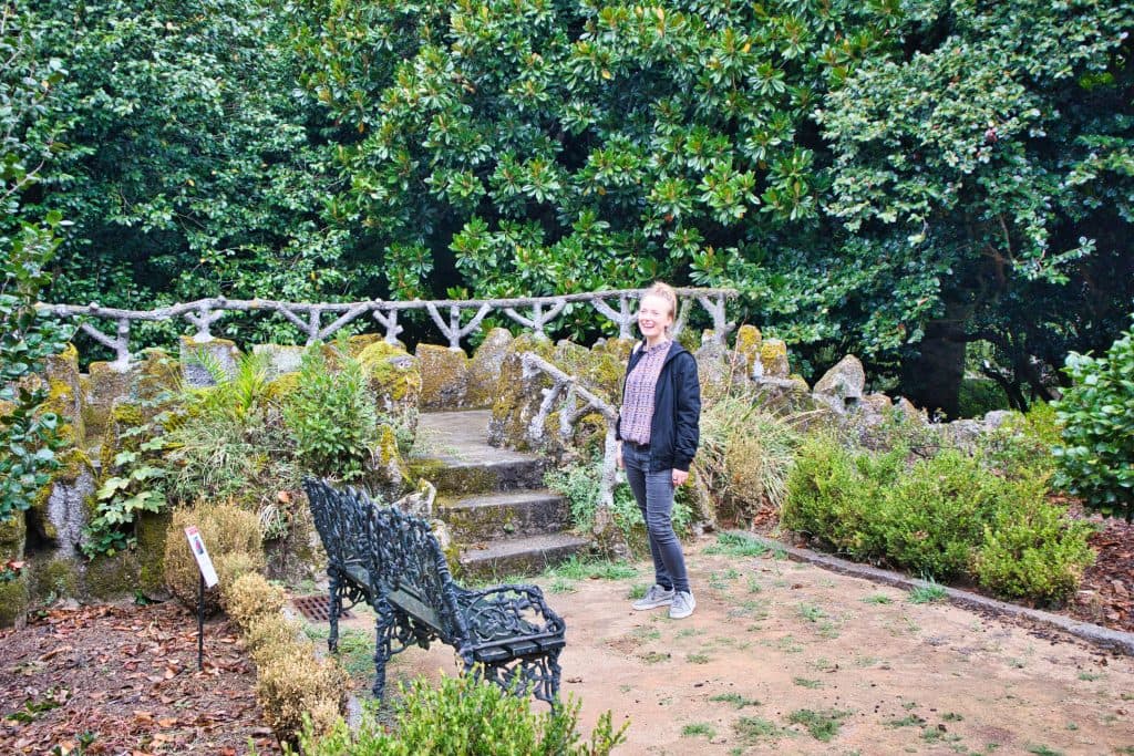 magda horanin is laughing among green trees in a small park in porto