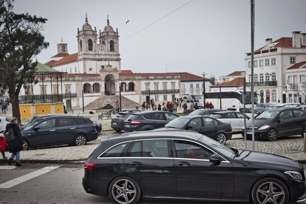 parking in nazare filled with cars near the main square