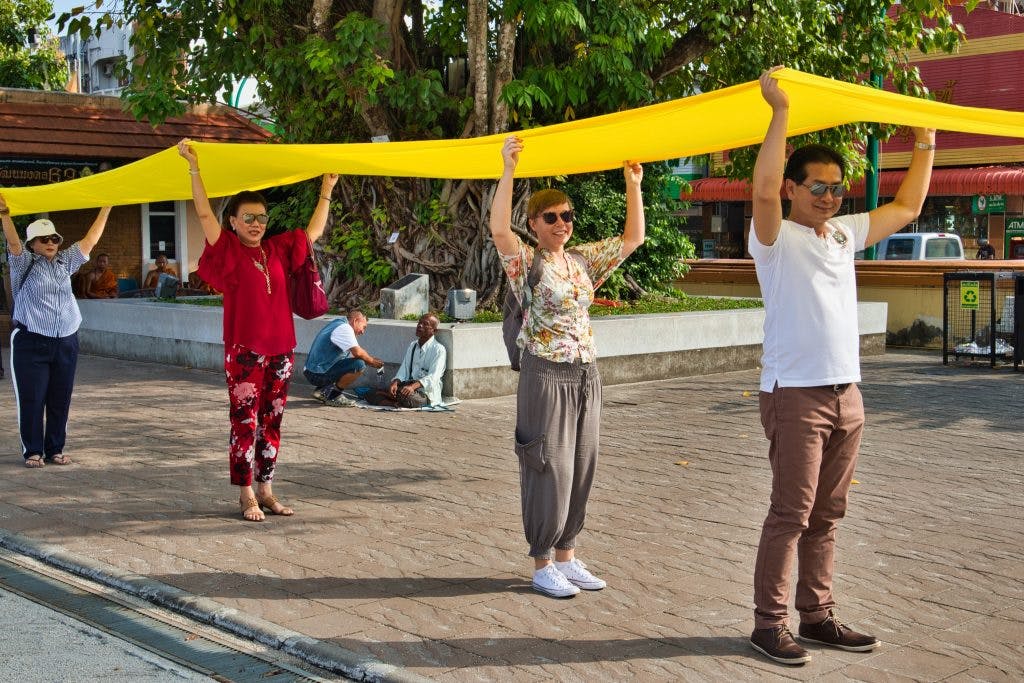 a foreign woman taking part in Buddhist celebration in nakhon si thammarat 
