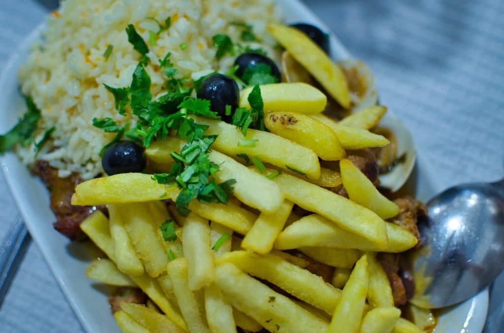 fries and rice on a plate at a tasca in lisbon