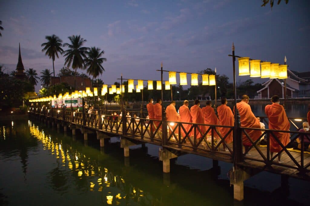 Monks waiting for morning alms in sukothai, thailand.