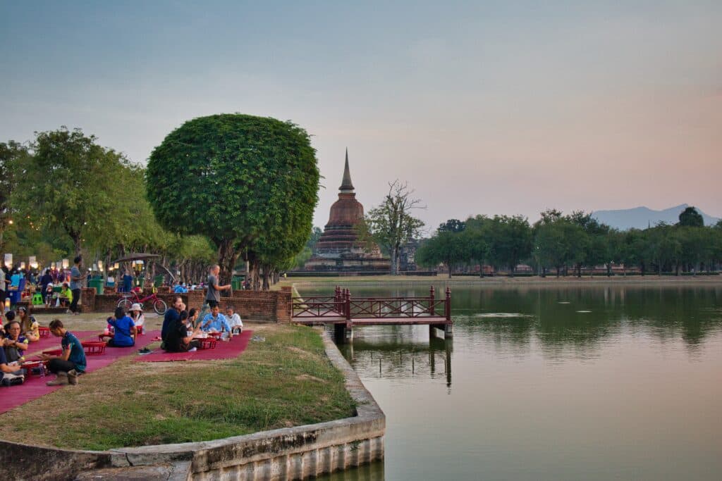 People sitting during the night market in Sukothai.