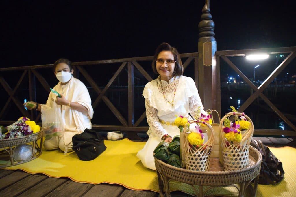 A thai woman with a basked of gifts for monks.