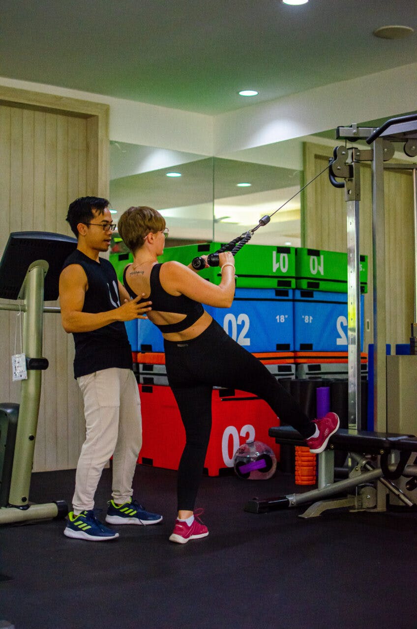 A woman and a man exercising at the gym at Absolute Sanctuary, Koh Samui. 