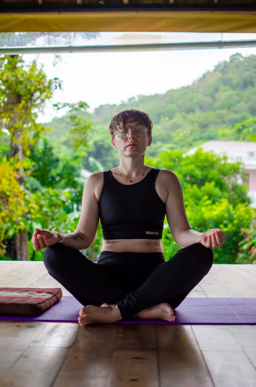 a woman meditating in the rain at absolute sanctuary koh samui.