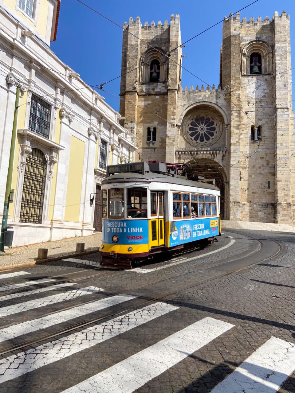 Old church, yellow tram, Lisbon, Portugal