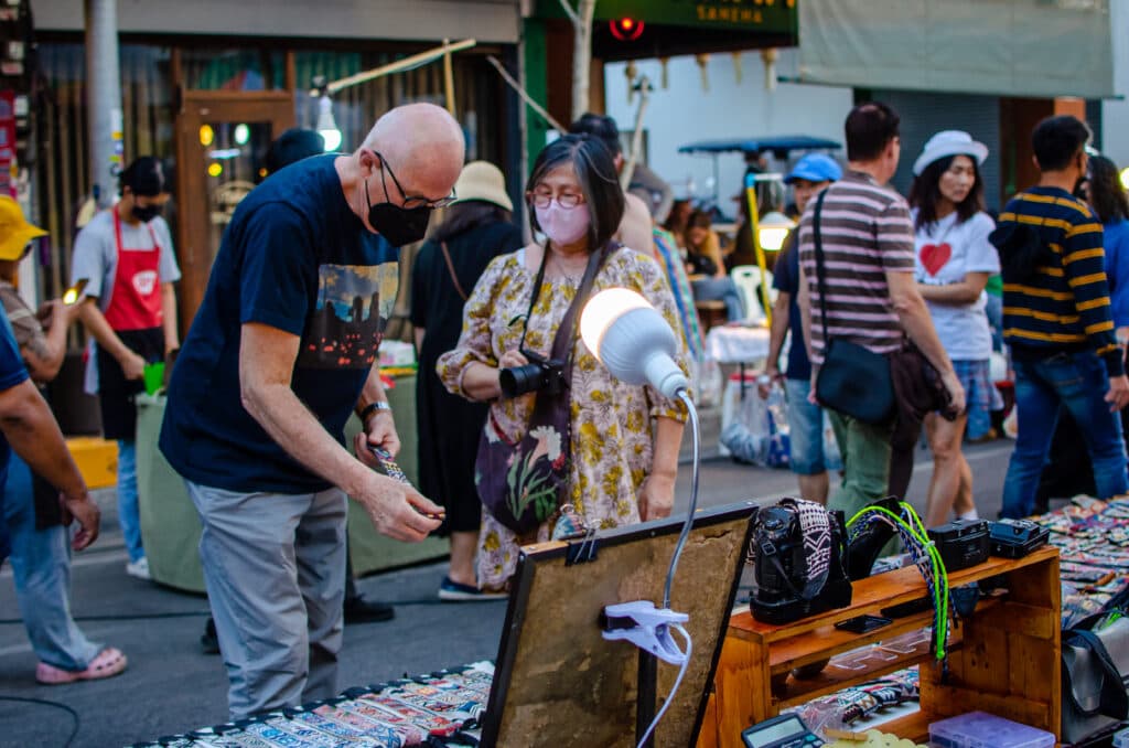 An older couple shopping at a night market in Chiang Mai.