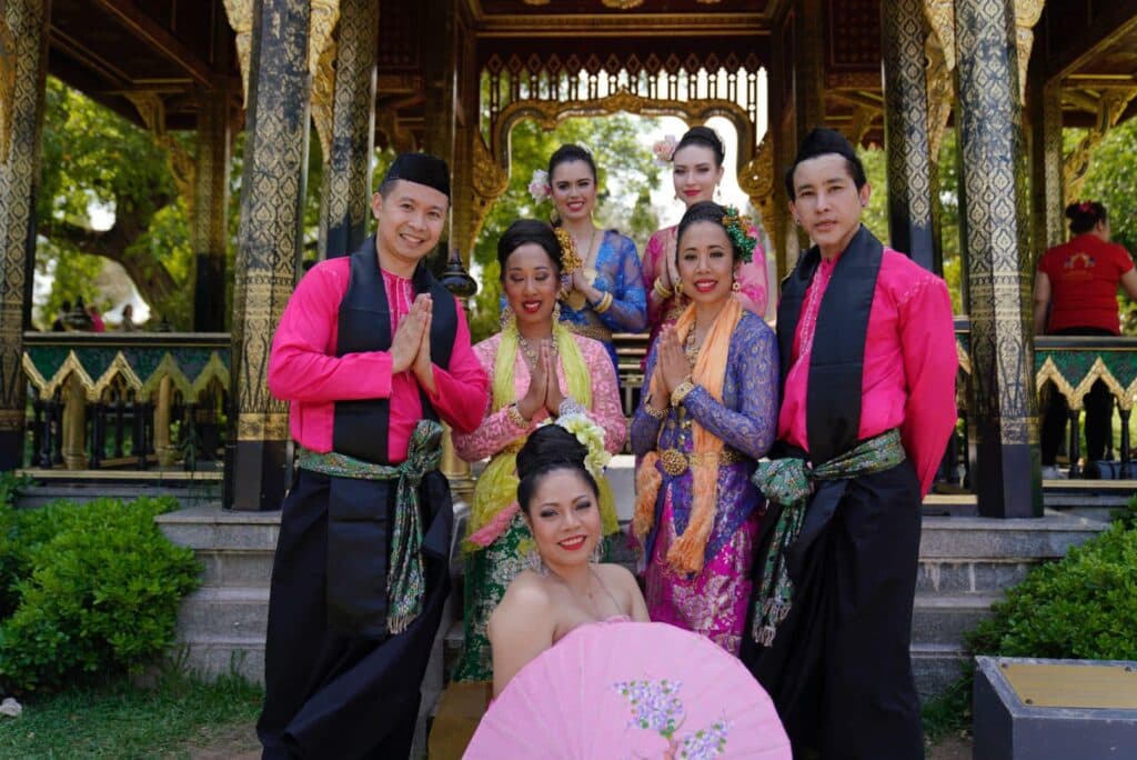 A group of Thai dancers dressed in beautiful costumes pose in a sala, thai festival, lisbon, portugal.