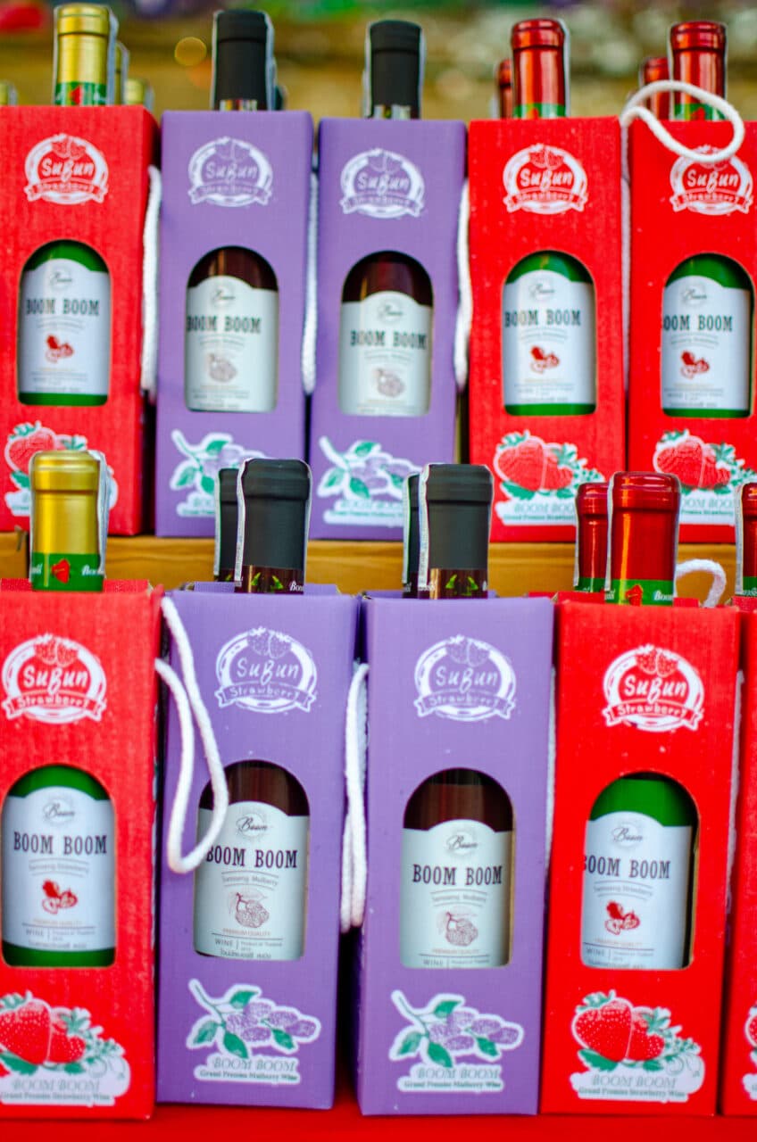 Stacks of strawberry wine at the thai strawberry festival.