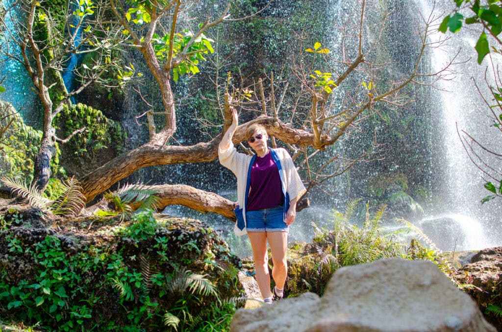 Joanna stands at a waterfall in a park in Chiang Mai. 
